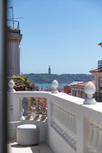 a white balcony with a view of the water at Montecarmo12 - Design Boutique Hotel in Lisbon