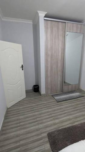 a room with a white door and a wooden floor at Kumalo apartment in Lusaka