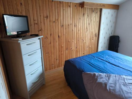 une chambre avec un lit et une télévision sur une commode dans l'établissement Les VAGUES DE LA GARDIOLE, à Vic-la-Gardiole
