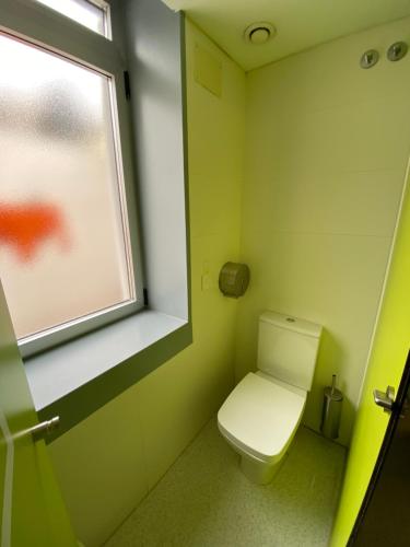 a small bathroom with a toilet and a window at Scout Madrid Hostel in Madrid