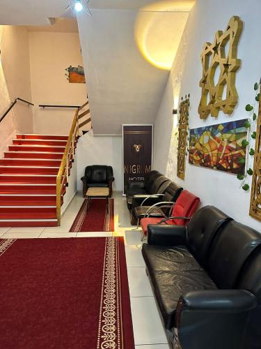 a living room with a couch and a staircase at NIGRUM HOTEL in Nevsehir