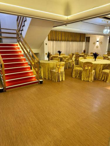 a banquet hall with tables and chairs and a staircase at NIGRUM HOTEL in Nevsehir