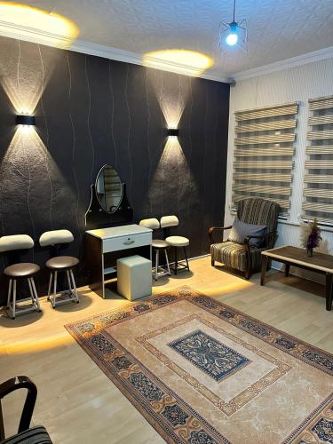 a living room with a table and chairs and a rug at NIGRUM HOTEL in Nevsehir