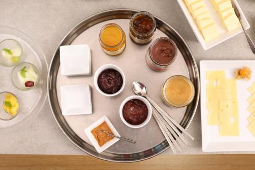 a plate of food with cheese and desserts on it at Hotel an der Marienkirche in Lübeck