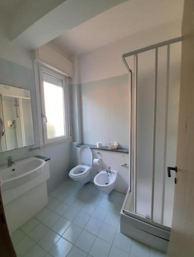 a bathroom with a toilet and a sink and a shower at Residence Le Vele in Cattolica