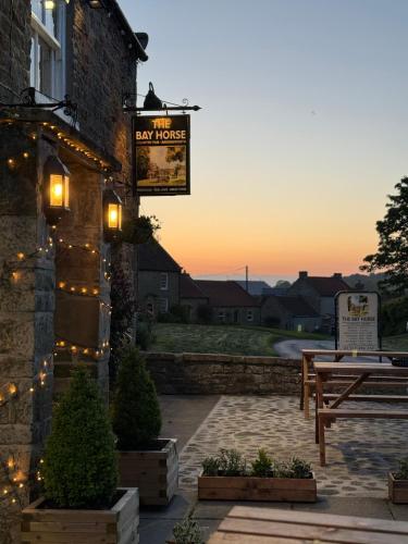 a sign on the side of a building with lights at Chestnut Cottage Ravensworth in Richmond