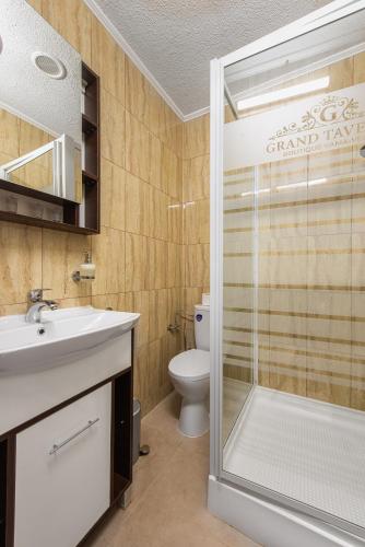 a bathroom with a toilet and a sink and a shower at Grand Taverna Boutique -Adults Only in Vama Veche