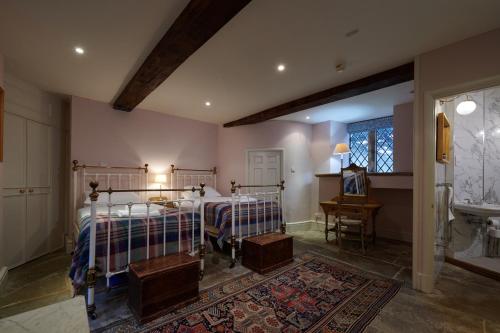 a bedroom with two beds and a sink at The Hunting Tower in Baslow