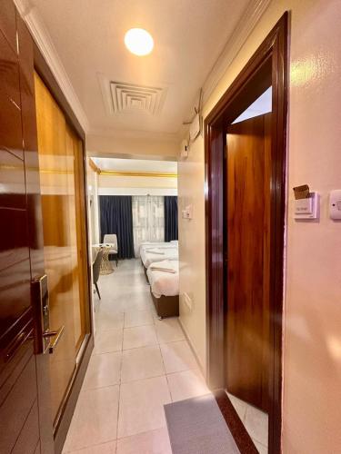 a hallway with a room with a bed and a door at Galaxy Star Hotel in Dubai
