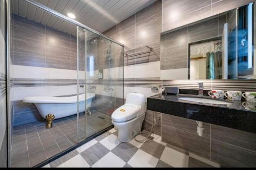 a bathroom with a tub and a toilet and a sink at Hualien Professor's Home B&B No. 2198 in Jian