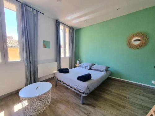 - une chambre avec un lit dans un mur vert dans l'établissement Studio équipé et rénové, centre historique, à Aix-en-Provence