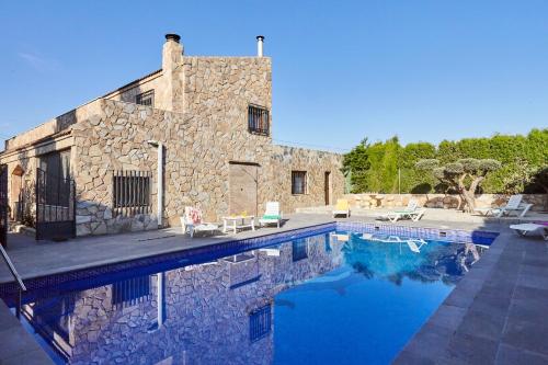 a stone house with a swimming pool in front of it at Alojamiento Rural Soler in Pozo Alcón