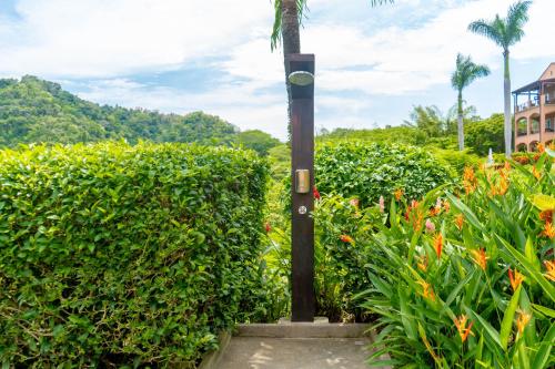 a street light in front of a hedge at Luxury, ocean view, 3-bedroom condo @ Los Sueños in Herradura