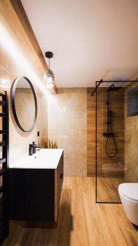 a bathroom with a sink and a mirror at Dream House - Vysoké Tatry in Vysoké Tatry
