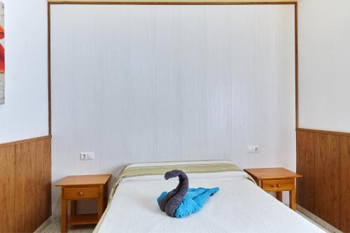 a swan laying on a bed in a bedroom at Alojamiento Rural Soler in Pozo Alcón