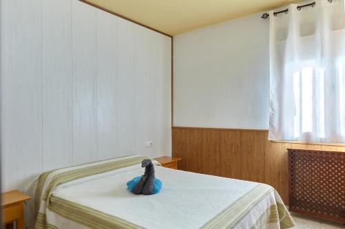a stuffed elephant sitting on a bed in a room at Alojamiento Rural Soler in Pozo Alcón