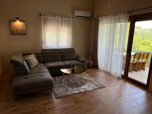 a living room with a couch and a table at Green House in Virpazar