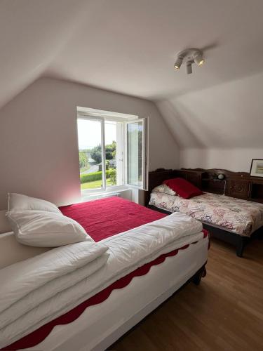 une chambre avec deux lits et une fenêtre dans l'établissement Maison de ville à la mer très bien équipée proche centre avec commerces, à Plouescat