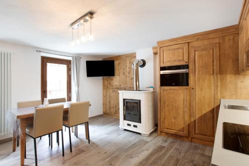 a kitchen with a table and chairs and a stove at Les Cles - Achillea in Valsavarenche