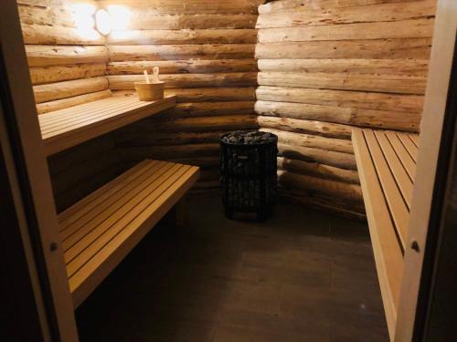 a sauna with two benches and a trash can at FeWo zum Heuweg in Hofkirchen