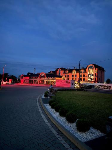 a building is lit up at night with red lights at Hotel Zefir in Drohobytsch