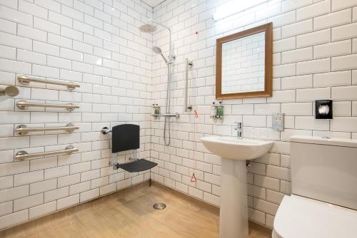 a white bathroom with a sink and a mirror at The Seaton Lane Inn - The Inn Collection Group in Seaham