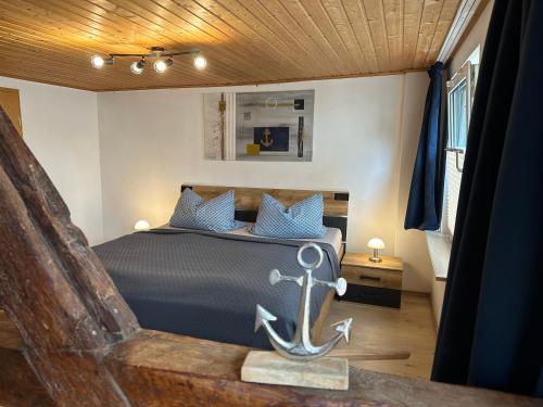 a bedroom with a bed with an anchor on it at Ankerplatz Barth in Barth