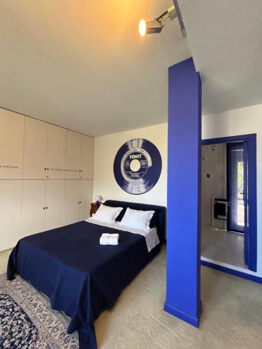 a bedroom with a bed with a blue column at Spazio DIBA in Ortona