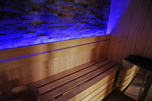 a wooden bench in a room with a brick wall at Maison du Lac 4 in Vielsalm