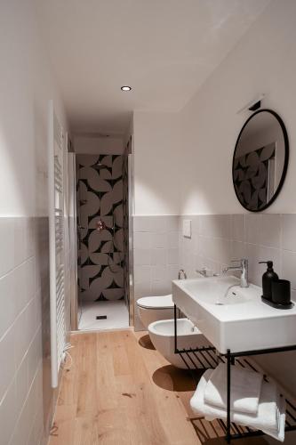 a white bathroom with a sink and a toilet at Paramar Casa Vacanza Conversano in Conversano