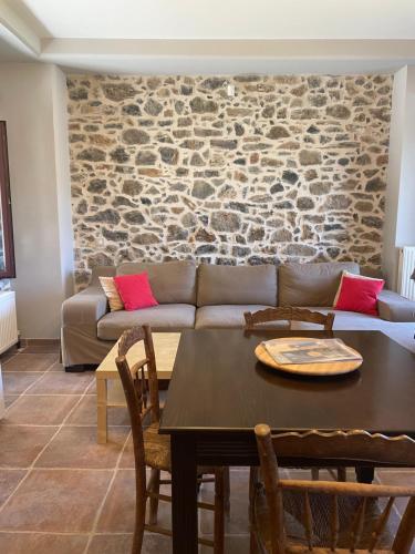 a living room with a couch and a table at Traditional Cottage in Veliés