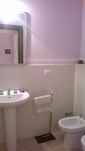 a bathroom with a sink and a toilet at B&B Ciliegio Felice in Molinella
