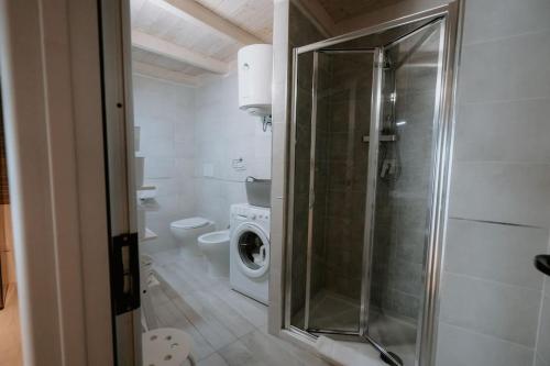 a bathroom with a washing machine and a washer at Le Vele Apartment San Salvo Marina in Marina di Montenero