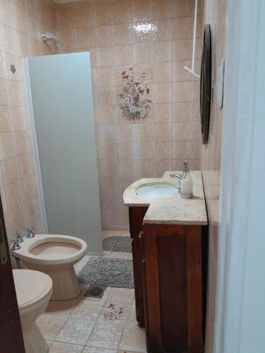 a bathroom with a sink and a toilet and a shower at CASA CENTRO Avenida Peron in La Rioja
