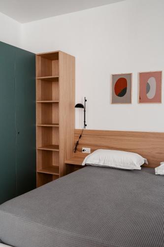 a bedroom with a bed and a book shelf at Paramar Casa Vacanza Conversano in Conversano