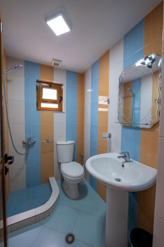 a bathroom with a toilet and a sink at Vila Ylli Gjika in Ksamil