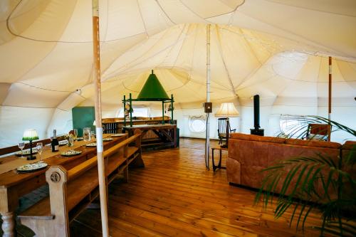 a large tent with tables and a couch in it at Luxury Glamping Retreat in Battle in Battle