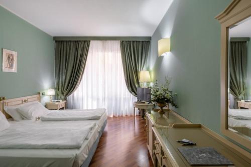 Ein Bett oder Betten in einem Zimmer der Unterkunft Hotel Lucrezia Borgia