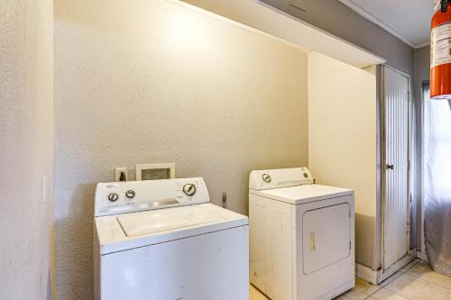 a laundry room with a washer and dryer at Spacious Orange Rental about 3 Mi to Museums and Garden! in Orange