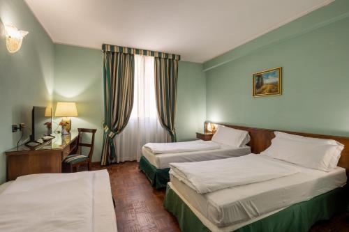 Ein Bett oder Betten in einem Zimmer der Unterkunft Hotel Lucrezia Borgia