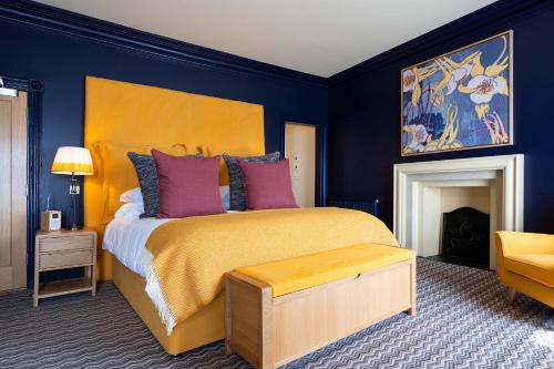 a bedroom with a king sized bed and a fireplace at The Shoregate in Crail