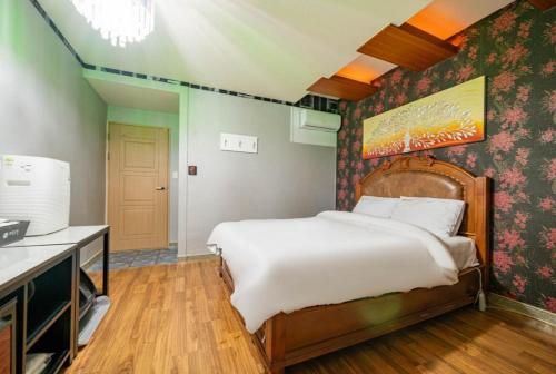 a bedroom with a large bed in a room at Andong hotel in Andong
