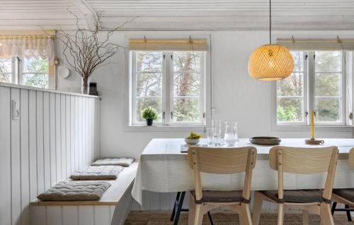 a dining room with a table and chairs and windows at Bakketop in Balke