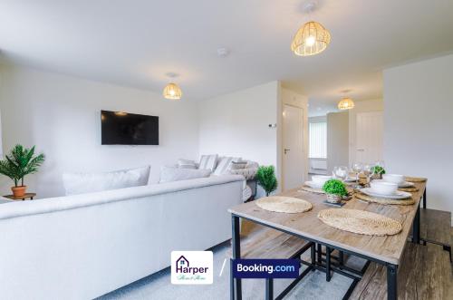 a living room with a white couch and a table at Spacious 5BR Contractor Stay Sleeps 10 in Chester in Hough Green