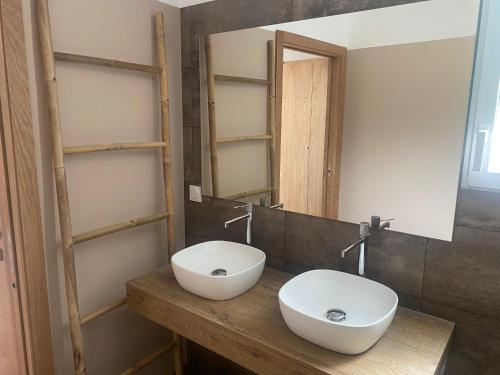 a bathroom with a white sink and a mirror at Résidence U Pirellu in Porto-Vecchio