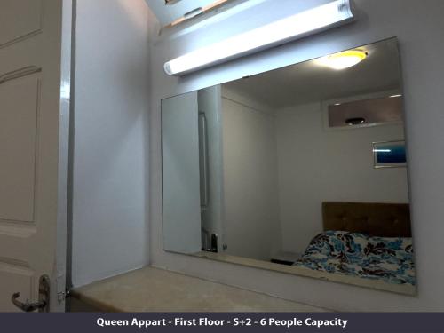 a mirror in a room with a bed in front of it at Tunisia Queen Apartment in Hammamet