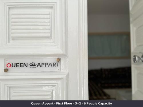 a white door with a sign on it at Tunisia Queen Apartment in Hammamet