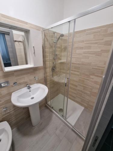 a bathroom with a shower and a sink and a toilet at Piazza Salotto in Corigliano Calabro