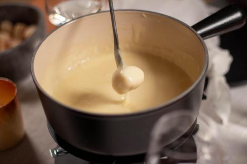 a spoon in a pot filled with liquid at Osteria Bäkar in Villa