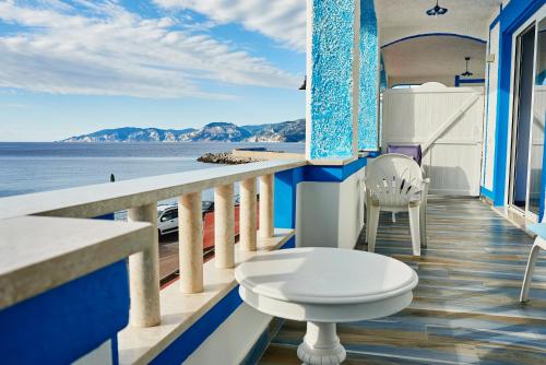 a balcony with a toilet and a view of the ocean at B&B AcquaDolce in Cala Gonone